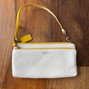 White and yellow coach wristlet